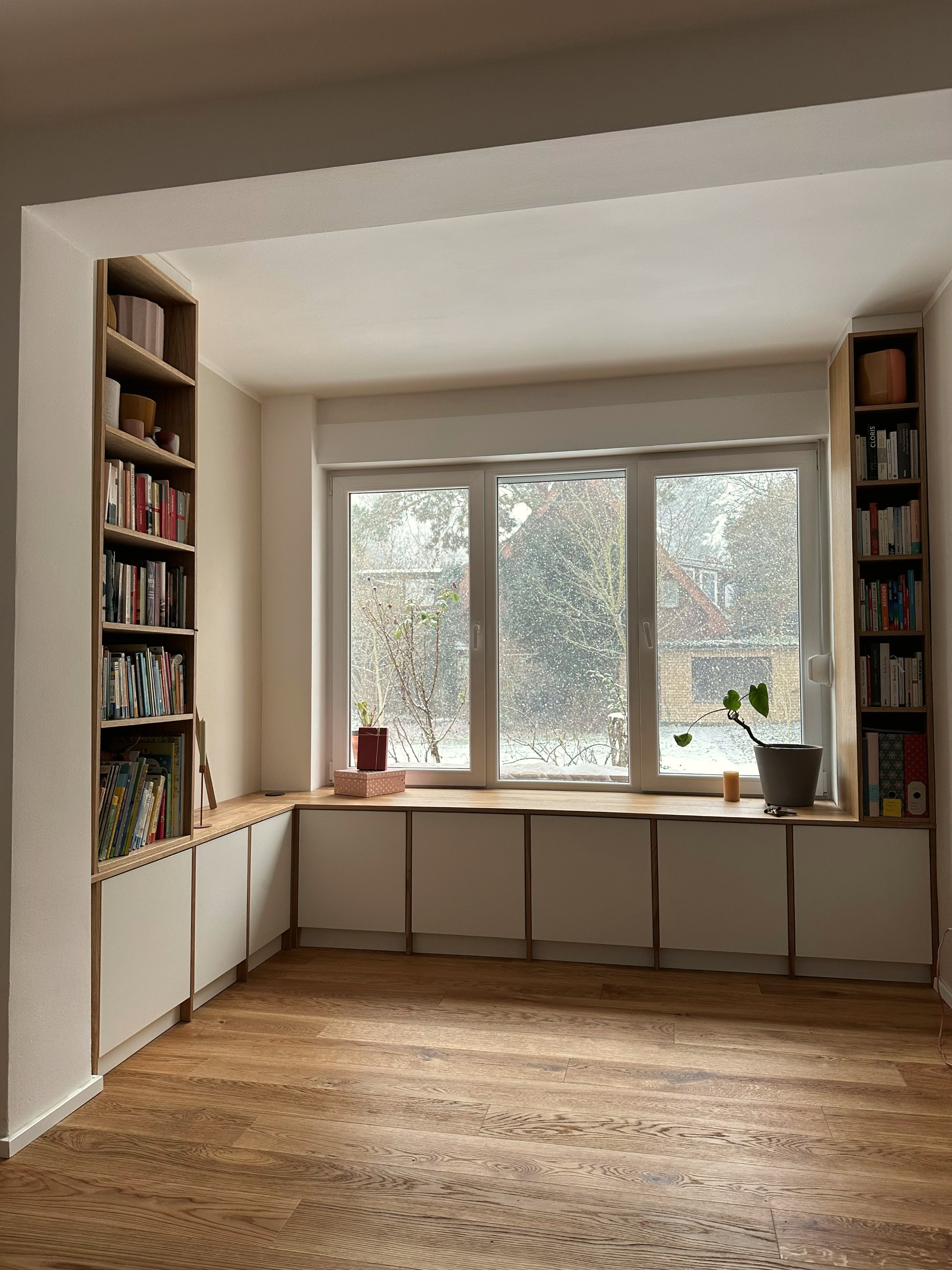 Sitzfensterbank mit Stauraum und flankierenden Bücherregalen aus Eiche – Referenz Möbel nach Maß Essen